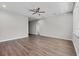 Spacious, light-filled living room with wood floors, ceiling fan and neutral paint at 4502 Fairway Oaks Dr, Mulberry, FL 33860