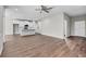 Open-concept living space with hardwood floors and a stylish kitchen featuring white cabinets at 4502 Fairway Oaks Dr, Mulberry, FL 33860