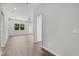 Open-concept living room with hardwood floors, bright natural light, and modern ceiling fan at 4502 Fairway Oaks Dr, Mulberry, FL 33860