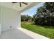 Covered patio overlooking lush green yard, perfect for outdoor enjoyment and relaxation at 4502 Fairway Oaks Dr, Mulberry, FL 33860