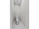 Small water closet featuring a toilet and hexagon tile flooring at 4502 Fairway Oaks Dr, Mulberry, FL 33860