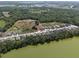 Aerial view of a neighborhood featuring waterfront properties with mature trees and serene lake views at 4537 Fairway Oaks Dr, Mulberry, FL 33860