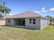 Back exterior featuring covered patio and spacious yard at 4537 Fairway Oaks Dr, Mulberry, FL 33860