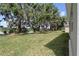 Spacious backyard with mature trees, lush lawn, and tranquil lake views, perfect for outdoor enjoyment at 4537 Fairway Oaks Dr, Mulberry, FL 33860