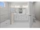 Bright bathroom with a double sink vanity, glass shower and marble-look flooring at 4537 Fairway Oaks Dr, Mulberry, FL 33860