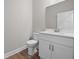 Well-lit half bathroom featuring modern fixtures, a clean white vanity, and tile flooring for a fresh feel at 4537 Fairway Oaks Dr, Mulberry, FL 33860