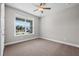 Bedroom featuring neutral walls, plush carpet, and a window with a peaceful view at 4537 Fairway Oaks Dr, Mulberry, FL 33860