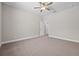 A spacious bedroom offers neutral walls, carpeted floors, and a ceiling fan at 4537 Fairway Oaks Dr, Mulberry, FL 33860
