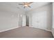 The bedroom offers neutral walls, carpeted floors, and entryways to the closet and bathroom at 4537 Fairway Oaks Dr, Mulberry, FL 33860