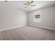 A bright bedroom features neutral walls, carpeted floors, and a window, creating a peaceful space at 4537 Fairway Oaks Dr, Mulberry, FL 33860