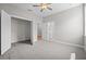 The bedroom showcases neutral walls, carpeted floors, and entryways to the closet and bathroom at 4537 Fairway Oaks Dr, Mulberry, FL 33860