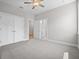 Bedroom with large closet, ceiling fan, and ensuite bath at 4537 Fairway Oaks Dr, Mulberry, FL 33860