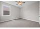 A cozy bedroom features neutral walls, carpeted floors, a window, and a ceiling fan at 4537 Fairway Oaks Dr, Mulberry, FL 33860
