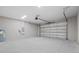 Spacious garage with ample room for parking and storage, featuring bright lighting and a clean concrete floor at 4537 Fairway Oaks Dr, Mulberry, FL 33860