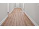 Hallway showcasing new hardwood floors and clean, neutral colored walls at 4537 Fairway Oaks Dr, Mulberry, FL 33860