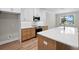 Stylish kitchen with island, white countertops and wood cabinets at 4537 Fairway Oaks Dr, Mulberry, FL 33860