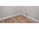 Laundry room featuring modern wood floors and utility connections for a convenient laundry experience at 4537 Fairway Oaks Dr, Mulberry, FL 33860