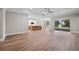 Spacious living room with hardwood floors and view of kitchen and backyard at 4537 Fairway Oaks Dr, Mulberry, FL 33860