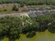 Aerial view of lakefront property surrounded by mature trees at 4541 Fairway Oaks Dr, Mulberry, FL 33860