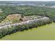 Aerial view showcasing community near a lake and surrounded by lush greenery at 4541 Fairway Oaks Dr, Mulberry, FL 33860