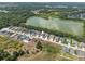 Aerial view of the community with lake views and well-maintained landscaping at 4541 Fairway Oaks Dr, Mulberry, FL 33860
