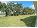 Expansive green backyard featuring mature trees offering shade and privacy to the home at 4541 Fairway Oaks Dr, Mulberry, FL 33860