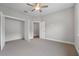 Bright bedroom with carpet, ceiling fan and doorways to other rooms providing a flexible and inviting space at 4541 Fairway Oaks Dr, Mulberry, FL 33860