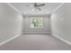 Spacious bedroom with ceiling fan, recessed lights, and a large window view at 4541 Fairway Oaks Dr, Mulberry, FL 33860