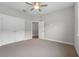 Bright bedroom with neutral carpet, a ceiling fan, and a double-door closet, offering ample storage at 4541 Fairway Oaks Dr, Mulberry, FL 33860