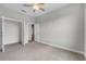 Neutral-toned bedroom with carpet, a ceiling fan, and a doorway to another room providing flexible space at 4541 Fairway Oaks Dr, Mulberry, FL 33860