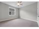 Neutral bedroom with carpet, a window, and a ceiling fan at 4541 Fairway Oaks Dr, Mulberry, FL 33860