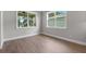Bedroom with two windows providing natural light at 4541 Fairway Oaks Dr, Mulberry, FL 33860