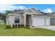 Single-story home with a two-car garage, landscaped yard and welcoming curb appeal at 4541 Fairway Oaks Dr, Mulberry, FL 33860