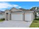 Single-story home with a two-car garage, landscaped yard, located in a serene setting at 4541 Fairway Oaks Dr, Mulberry, FL 33860
