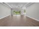 Expansive living area with wood-look floors, trey ceiling, and multiple windows at 4541 Fairway Oaks Dr, Mulberry, FL 33860