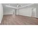 Large living room boasts wood-look floors, ceiling fan, and decorative trim at 4541 Fairway Oaks Dr, Mulberry, FL 33860