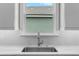 Close-up of a kitchen sink featuring a gooseneck faucet and white subway tile backsplash at 4541 Fairway Oaks Dr, Mulberry, FL 33860