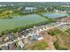 A neighborhood with single-Gathering homes is adjacent to a pond in this aerial view at 4545 Fairway Oaks Dr, Mulberry, FL 33860