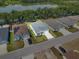 A high aerial view shows a neatly landscaped single-Gathering home with a gray roof at 4545 Fairway Oaks Dr, Mulberry, FL 33860