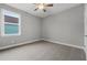Bedroom with carpeted floor, ceiling fan and window with exterior view at 4545 Fairway Oaks Dr, Mulberry, FL 33860