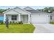 Charming single-Gathering home with a well-manicured lawn and a two-car garage at 4545 Fairway Oaks Dr, Mulberry, FL 33860