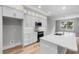 Well lit kitchen with stainless appliances, quartz countertops, and hardwood floors at 4545 Fairway Oaks Dr, Mulberry, FL 33860