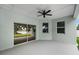 Covered lanai overlooking a peaceful lake with ample space for relaxing and entertaining at 4545 Fairway Oaks Dr, Mulberry, FL 33860