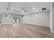 Well lit living room with hardwood floors and large sliding glass doors to covered porch at 4545 Fairway Oaks Dr, Mulberry, FL 33860