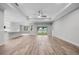 Bright living room with hardwood floors, modern ceiling fan, and sliding glass doors overlooking the lake at 4545 Fairway Oaks Dr, Mulberry, FL 33860