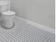 Close up on toilet with black and white hexagon tile floor at 4545 Fairway Oaks Dr, Mulberry, FL 33860
