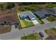 Aerial view of the house with a lush green lawn surrounded by neighboring homes at 4550 Fairway Oaks Dr, Mulberry, FL 33860