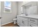 Bathroom featuring white cabinets, a modern sink, and a window overlooking the exterior at 4550 Fairway Oaks Dr, Mulberry, FL 33860