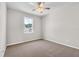 Cozy bedroom featuring carpet, a ceiling fan, and a window with natural light and neighborhood views at 4550 Fairway Oaks Dr, Mulberry, FL 33860