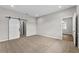 Open and airy bedroom boasts plush carpet, modern barn door, and ample space for customization at 4550 Fairway Oaks Dr, Mulberry, FL 33860